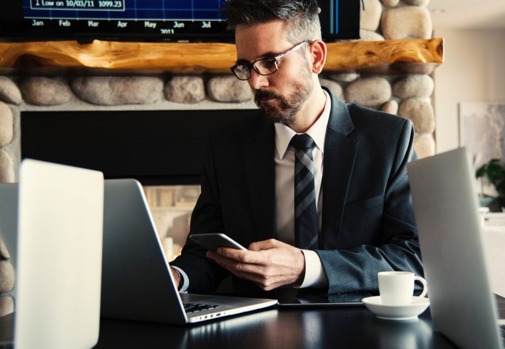 Man in black holding phone